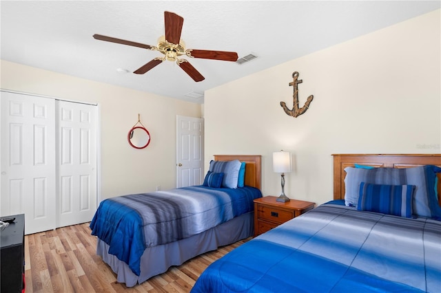 bedroom featuring visible vents, a closet, a ceiling fan, and light wood finished floors