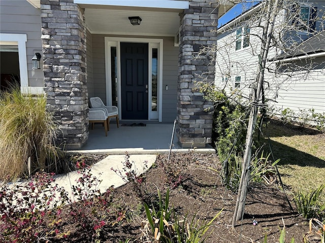 entrance to property featuring stone siding