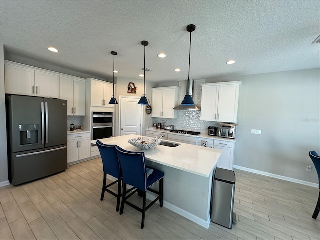 kitchen featuring backsplash, black appliances, wall chimney exhaust hood, and white cabinetry