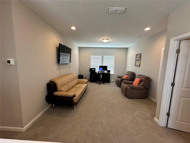 living area featuring recessed lighting, visible vents, a textured ceiling, and carpet flooring