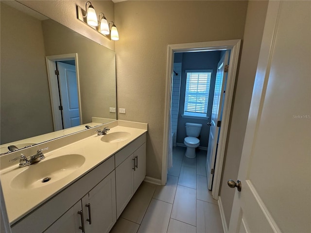 full bath featuring a sink, toilet, double vanity, and tile patterned floors