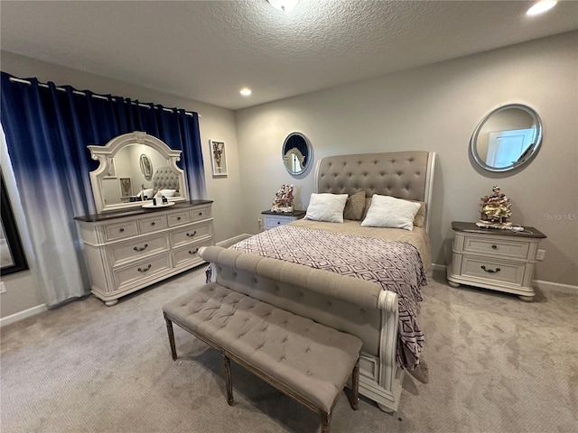 bedroom featuring recessed lighting, light colored carpet, baseboards, and a textured ceiling