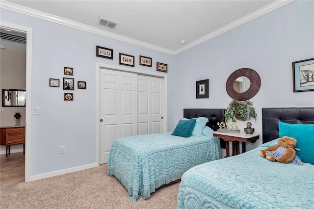 bedroom featuring baseboards, visible vents, carpet floors, and ornamental molding