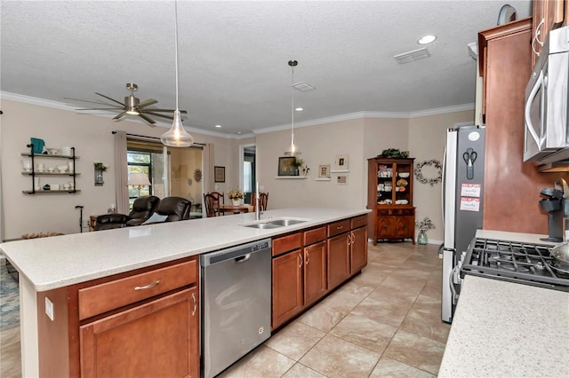 kitchen with visible vents, a sink, stainless steel appliances, light countertops, and open floor plan