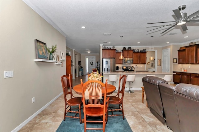 dining space featuring recessed lighting, baseboards, a textured ceiling, and ornamental molding