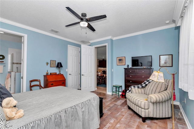 bedroom with a textured ceiling, wood finished floors, visible vents, and ornamental molding