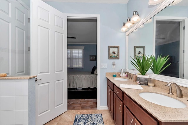 bathroom featuring double vanity, tile patterned floors, ensuite bathroom, and a sink