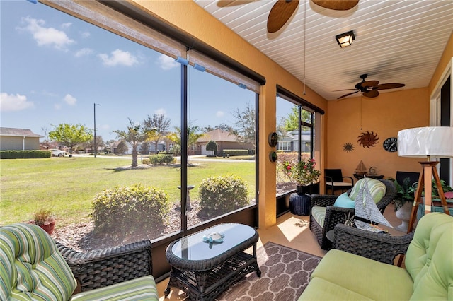 sunroom featuring ceiling fan