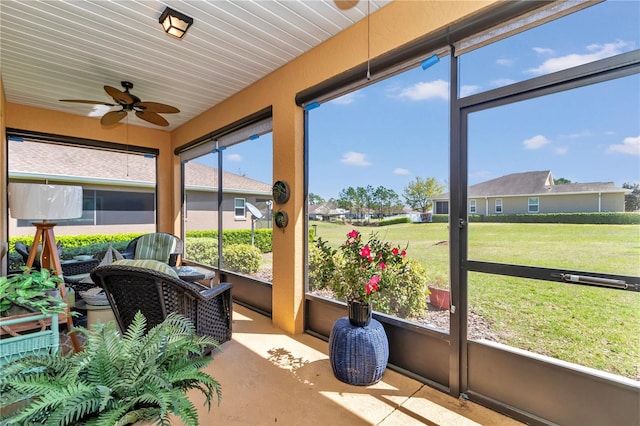 sunroom featuring ceiling fan