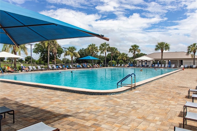 pool featuring a patio area and fence