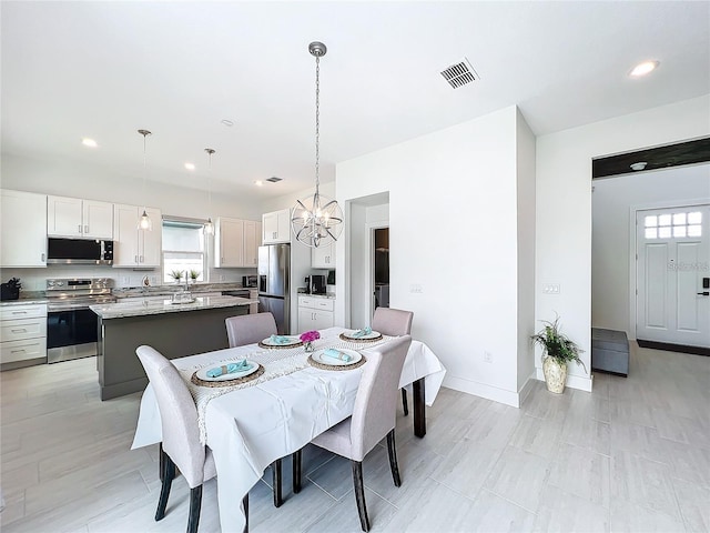 dining area featuring a chandelier, visible vents, recessed lighting, and baseboards