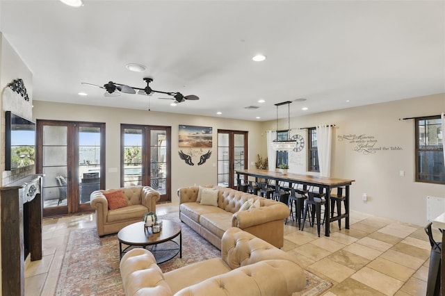 living room with visible vents, recessed lighting, french doors, and a ceiling fan