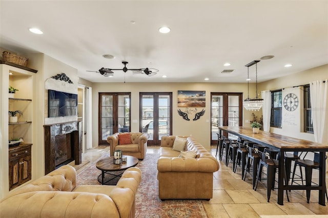 living room featuring recessed lighting, french doors, visible vents, and stone finish flooring