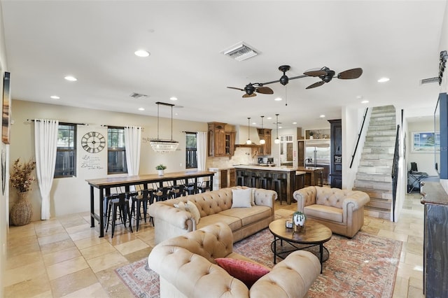 living room featuring stairs, recessed lighting, and visible vents