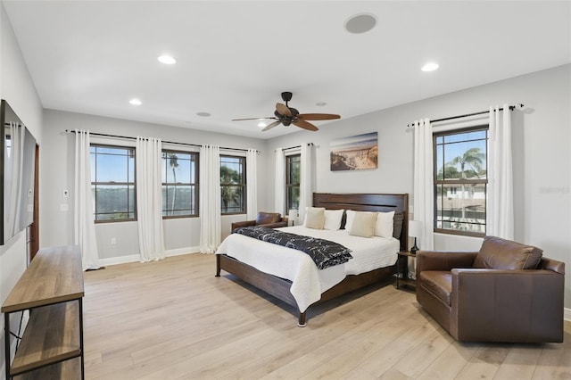 bedroom with recessed lighting, light wood-type flooring, and baseboards