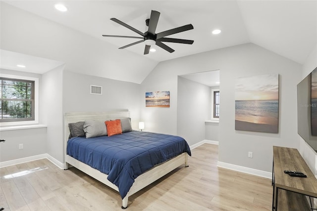 bedroom with visible vents, baseboards, lofted ceiling, and wood finished floors