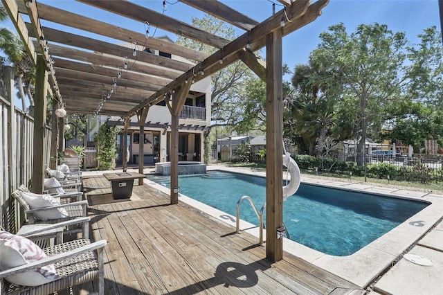 view of pool with a pool with connected hot tub, a deck, a pergola, and fence