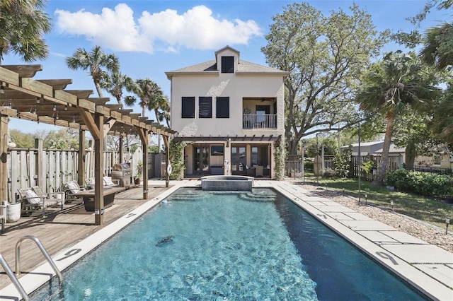 view of pool with a pool with connected hot tub, a pergola, a patio, and fence