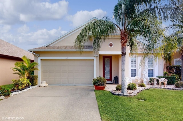 view of front of home with concrete driveway, an attached garage, a front yard, and stucco siding