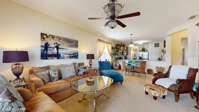 living room with tile patterned flooring, carpet flooring, a ceiling fan, and visible vents