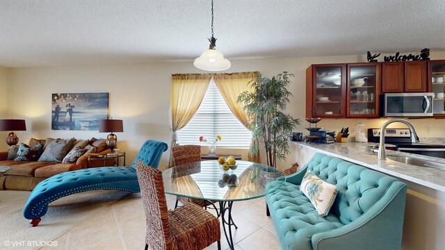 dining area with light tile patterned floors and a textured ceiling