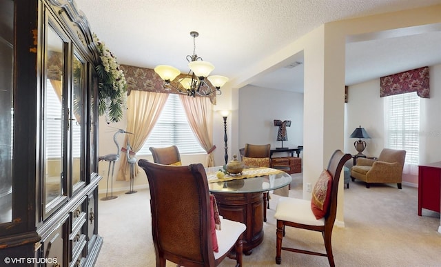 dining space featuring visible vents, light carpet, a textured ceiling, baseboards, and a chandelier