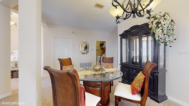 dining area featuring light carpet, visible vents, a textured ceiling, and baseboards