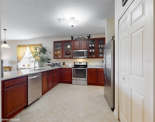 kitchen featuring a sink, light countertops, visible vents, and stainless steel appliances