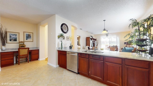 kitchen with a sink, a textured ceiling, dishwasher, and built in desk