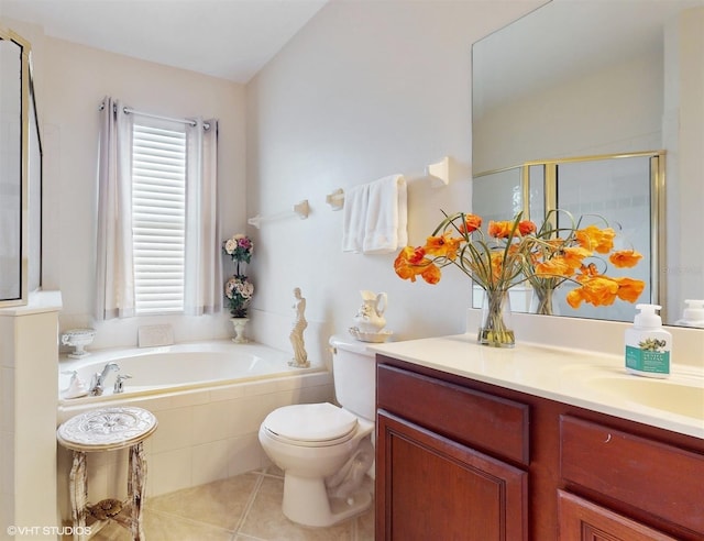 bathroom featuring vanity, a stall shower, tile patterned flooring, a garden tub, and toilet