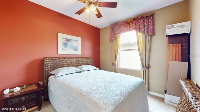 bedroom featuring baseboards, light colored carpet, and a ceiling fan