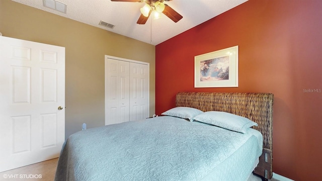 bedroom with a ceiling fan, visible vents, and a closet