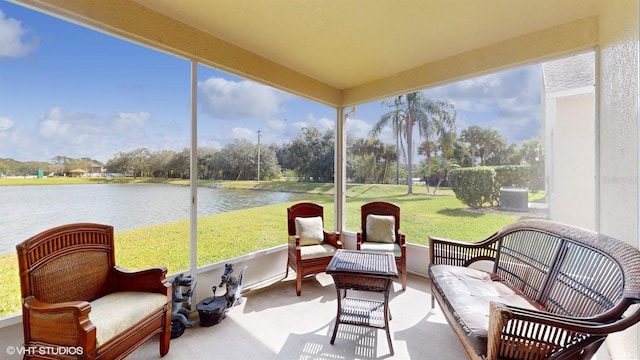 sunroom / solarium featuring a water view