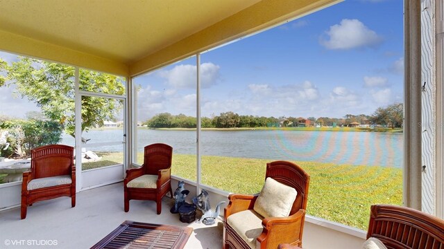 sunroom / solarium featuring a water view