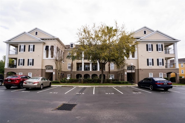 view of property featuring uncovered parking