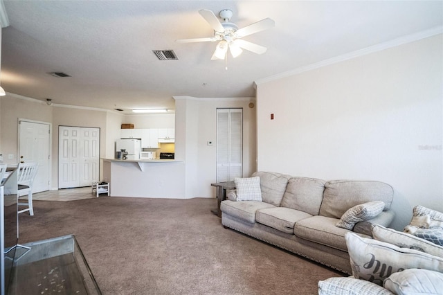 carpeted living room featuring a ceiling fan, visible vents, and ornamental molding