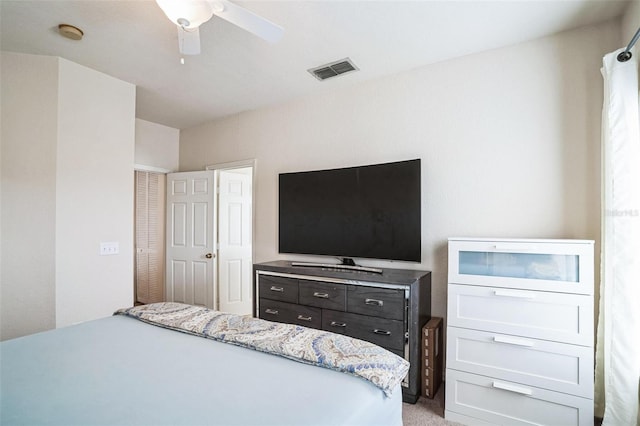 bedroom with a ceiling fan, visible vents, and light carpet