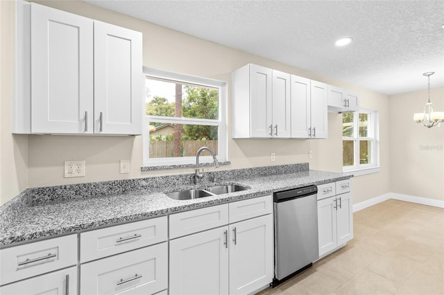 kitchen with light stone counters, an inviting chandelier, a sink, stainless steel dishwasher, and decorative light fixtures