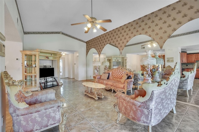 living area featuring a ceiling fan, high vaulted ceiling, wallpapered walls, light tile patterned flooring, and arched walkways