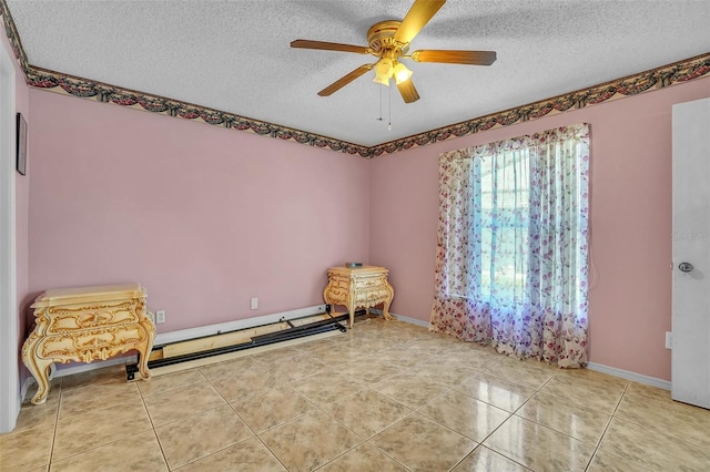 interior space with a textured ceiling, light tile patterned floors, a ceiling fan, and a baseboard radiator