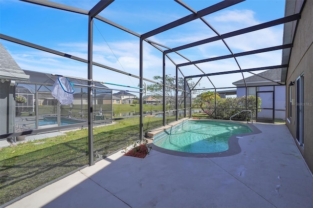 pool featuring glass enclosure, a patio area, a lawn, and a residential view