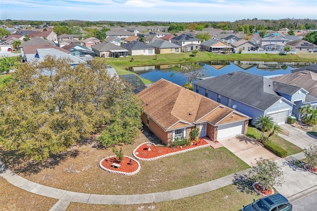 drone / aerial view with a residential view and a water view