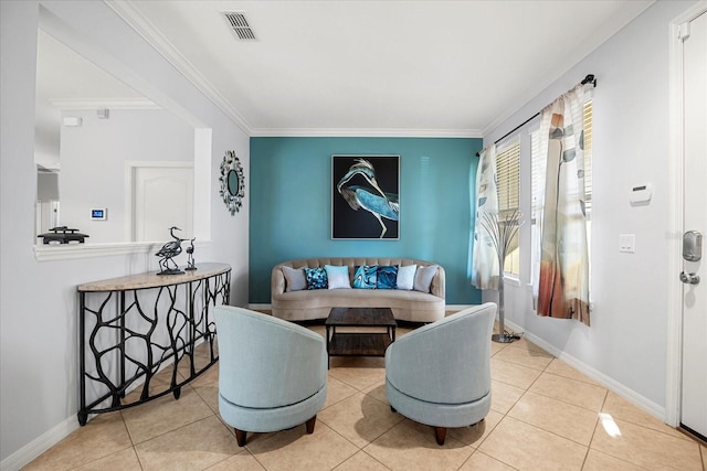 tiled dining space with crown molding, baseboards, and visible vents