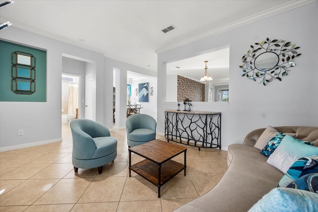 living area featuring visible vents, baseboards, crown molding, and tile patterned flooring