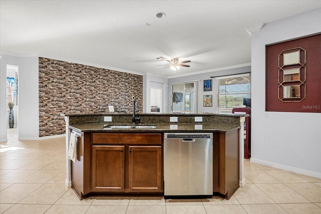 kitchen featuring dishwasher, crown molding, dark stone counters, and a sink