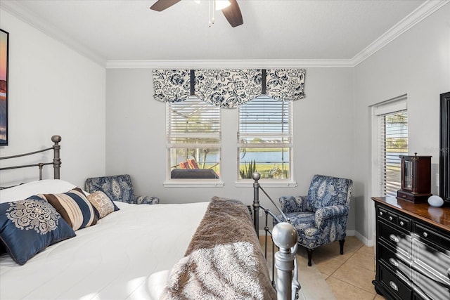 bedroom featuring crown molding, light tile patterned floors, a ceiling fan, and baseboards