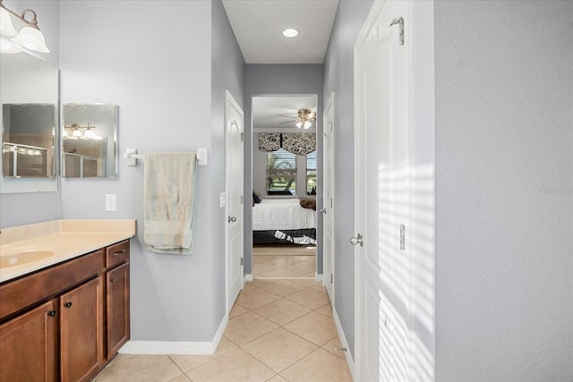 bathroom featuring tile patterned flooring, baseboards, ensuite bathroom, vanity, and a ceiling fan