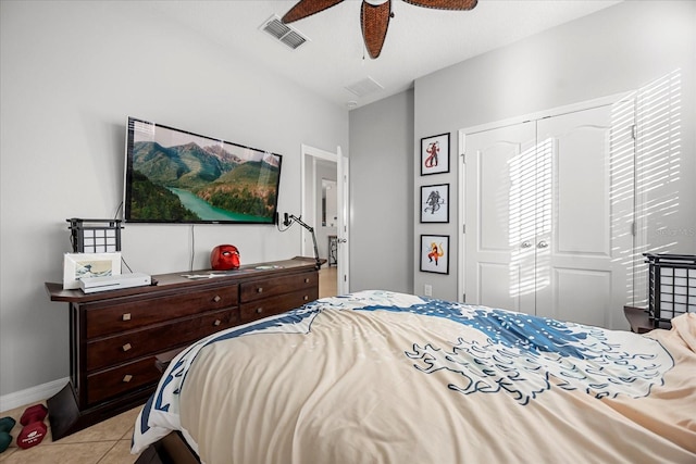 tiled bedroom with visible vents, baseboards, a closet, and a ceiling fan