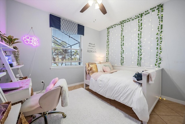 bedroom featuring tile patterned flooring, baseboards, and ceiling fan