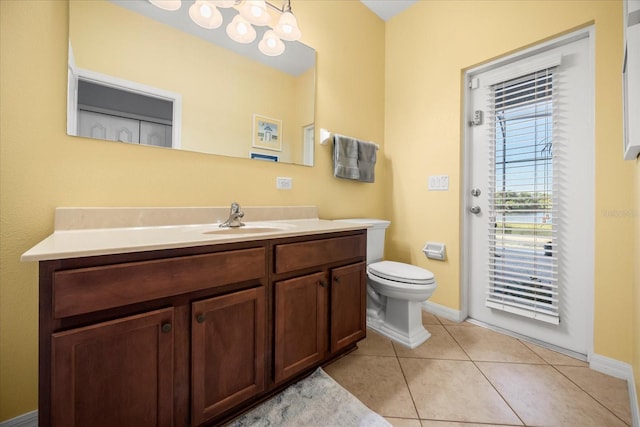 bathroom with tile patterned floors, a notable chandelier, toilet, baseboards, and vanity